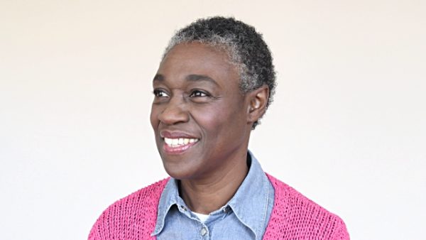 Mature woman smiling and looking at camera, she is confident and cheerful